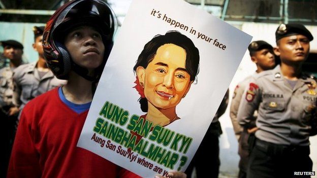 Student holds poster of Aung San Suu Kyi