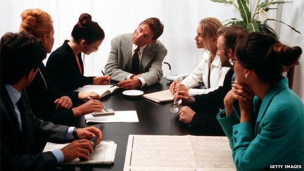 Stock photo of business people meeting around a desk