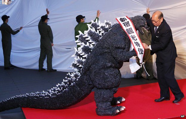 Godzilla gets a sash of "Shinjuku-ward tourism ambassador" during its awards ceremony in Tokyo on Thursday, 9 April, 2015