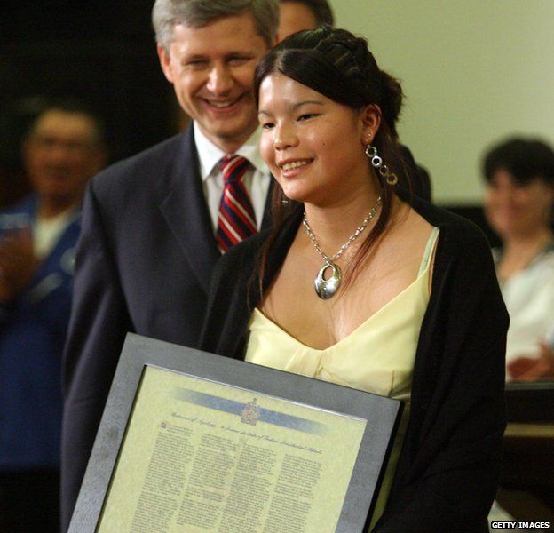 anadian Prime Minister Stephen Harper (L) smiles after presenting a framed statement of apology to Crystal Merasty, the youngest recipient of compensation, the Common Experience Payment, and a First Nations survivor of a residential school, on Parliament Hill June 11, 2008 in Ottawa, Canada.
