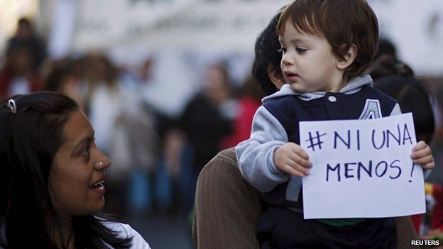 Child carries sign 'Ni una menos' in Buenos Aires. 3 June 2015