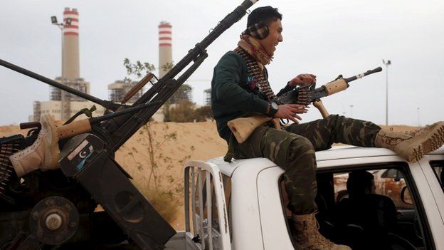 A fighter from Misrata sits on top of a vehicle near Sirte, March 16, 2015