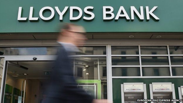 Pedestrians pass a Lloyds bank branch in central London