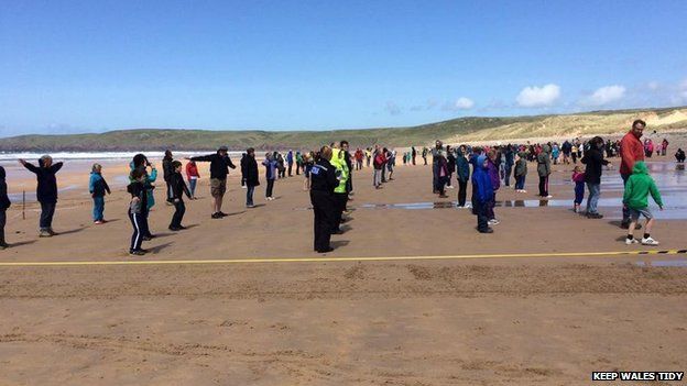 400 people attempt sand angels world record in Pembrokeshire - BBC News
