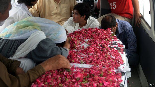 Pakistani relatives react next to the coffin of convicted activist Saulat Ali Khan also known as Saulat Mirza, following his execution in Karachi on May 12, 2015