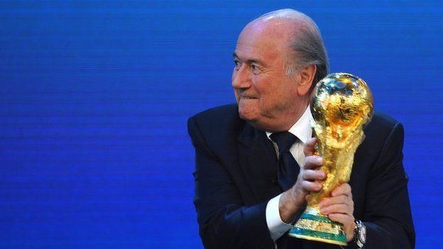 FIFA President Joseph S Blatter holds the world cup trophy, 2 December 2010