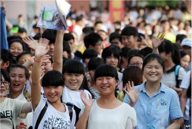 This picture taken on 8 June 2015 shows high school students walking out of a school after sitting the 2015 national college entrance examination, or the Gaokao, in Bozhou, east China's Anhui province
