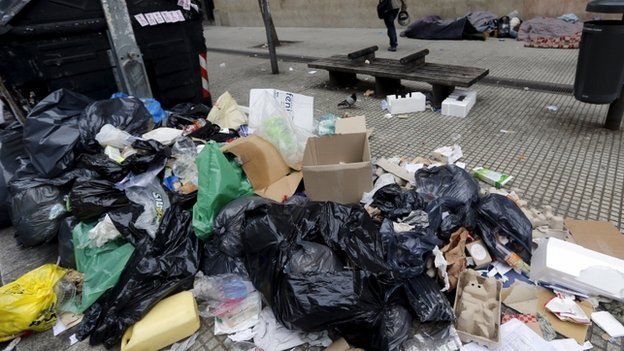 A pile of garbage is seen in the foreground during a 24-hour nationwide general strike in Buenos Aires, Argentina, June 9, 2015