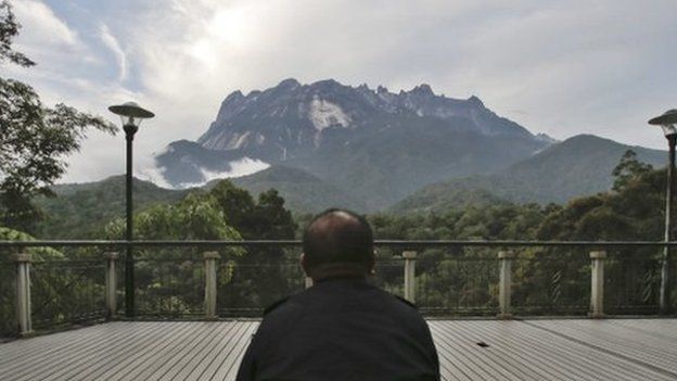 A policeman sits facing the Kinabalu Mountain as a rescue mission continues for more than 130 climbers stranded on one of Southeast Asia"s highest mountains after an earthquake, Sabah, in Kundasang, Malaysia, 6 June 2015.