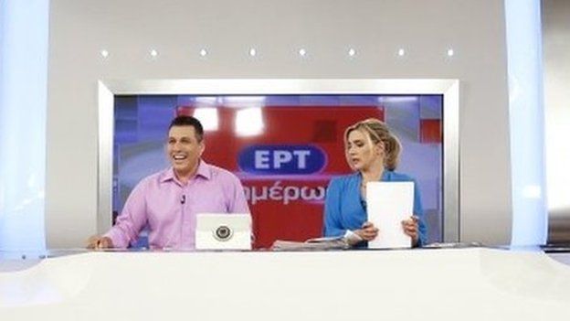 State television presenters Nikos Angelidis (L) and Vassiliki Haina prepare for the first broadcast of the station after its reopening in Athens June 11, 2015.