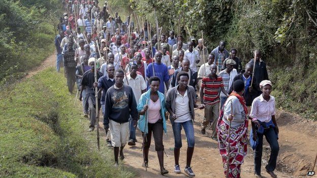 Demonstrators opposed to a third term for President Nkurunziza march before army soldiers shot in the air to disperse the protest, in the rural area of Mugongomanga, east of the capital Bujumbura, in Burundi