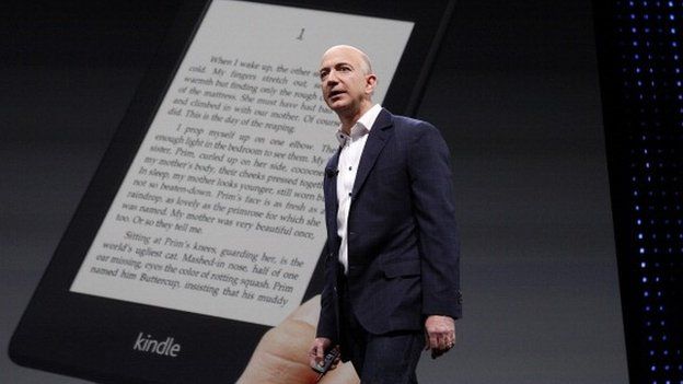 Amazon founder Jeff Bezos in front of Kindle screen