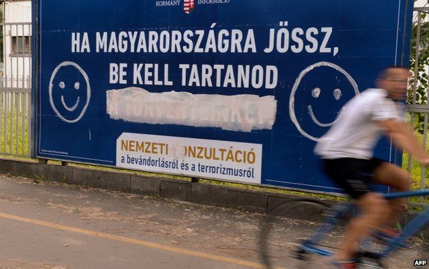 Anti-immigration poster defaced with smiley in Budapest