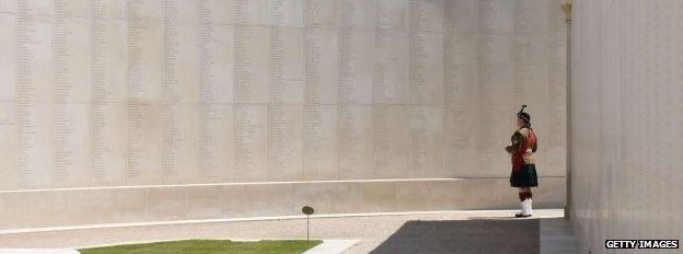 A member of the military observes the Armed Forces Memorial