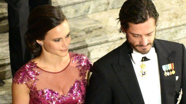 Prince Carl Philip of Sweden (right) and his fiancee Sofia Hellqvist arrive at the Nobel banquet at the Stockholm City Hall on 10 December 2014.