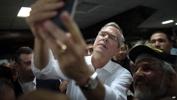 Former Florida Gov. Jeb Bush takes a selfie with a supporter"s phone after holding a town hall meeting with Puerto Rico"s Republican Party in Bayamon, Puerto Rico, Tuesday, April 28, 2015.