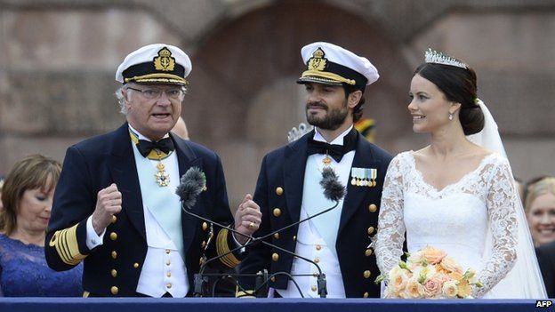 Sweden's King Carl XVI Gustaf (left) delivers a speech after the wedding of Princess Sofia (right) to Prince Carl Philip (centre) at Stockholm Palace (13 June 2015)