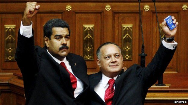 Venezuela's President Nicolas Maduro (L) gestures after being sworn into office by president of the National Assembly Diosdado Cabello (R) in Caracas April 19, 2013. Venezuela's powerful parliamentary chief, Diosdado Cabello, on May 19, 2015