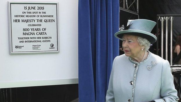 Queen Elizabeth II unveils a plaque at Runnymede, England, during a commemoration ceremony