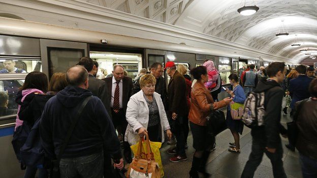 Commuters alighting from a Moscow metro train