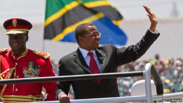 Tanzania�s re-elected president Jakaya Kikwete waves to supporters from a car as he arrives for the swearing-in ceremony at the Uhuru Stadium on November 6, 2010 in Dar Es Salaam