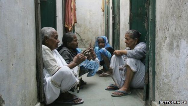 Indian widows chat outside their quarters at an ashram (spiritual commune)