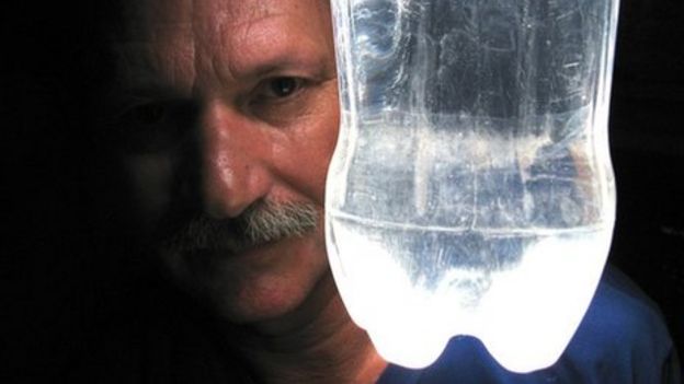 Alfredo Moser with one of his bottle lights