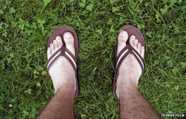 Man's sandaled feet