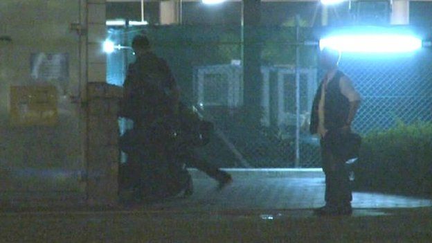A still image taken from video filmed by Hong Kong newspaper Apple Daily shows several police officers appeared to be beating and kicking a handcuffed protester after dragging him to a dark corner next to a protest site in Hong Kong early October 15, 2014.