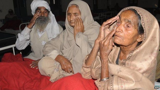Indian patients Gurbachan Singh, (L), Sampuran Kaur (C) and Pooro Kaur, who lost their eyesight after undergoing surgery at an eye camp, show their damaged eyes at a government hospital in Amritsar on December 5