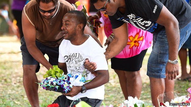 Mourner at memorial for Cairns victims