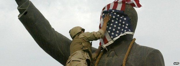 US flag on statue of Saddam Hussein