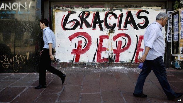 People walk past graffiti thanking Jose 'Pepe' Mujica, Uruguay's outgoing president - 28 February 2015