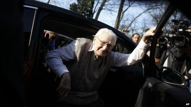 Former SS guard Oskar Groening steps out of a car as he arrives at the back entrance of the court hall prior to a trail against him in Lueneburg, northern Germany, 21 April 2015