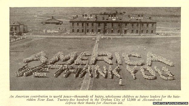 Hundreds of children form the words "America We Thank You"