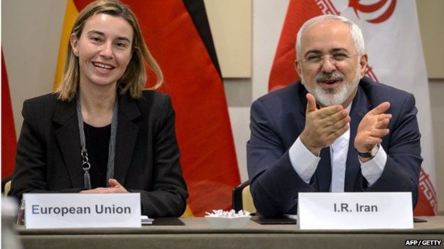 EU's foreign policy chief Federica Mogherini (L) and Iranian Foreign Minister Mohammad Javad Zarif smile ahead of the opening of a plenary session on Iran nuclear talks at the Beau Rivage Palace Hotel in Lausanne, Switzerland, on 30 March 2015