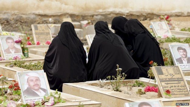 Women sit by the grave of a relative at a cemetery dedicated for Houthis killed in Yemen"s ongoing coflict, in Sanaa 5 April 2015