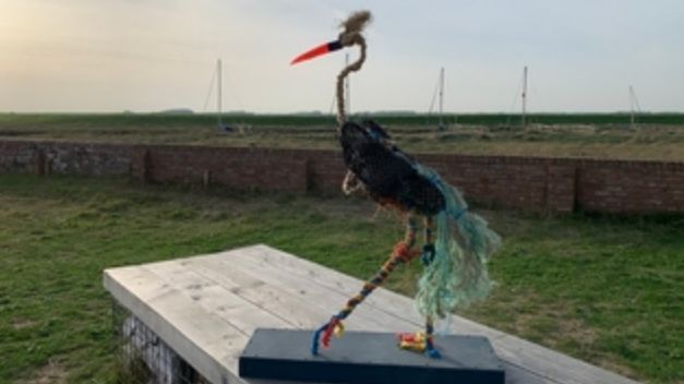 a heron sculpture made out of rubbish