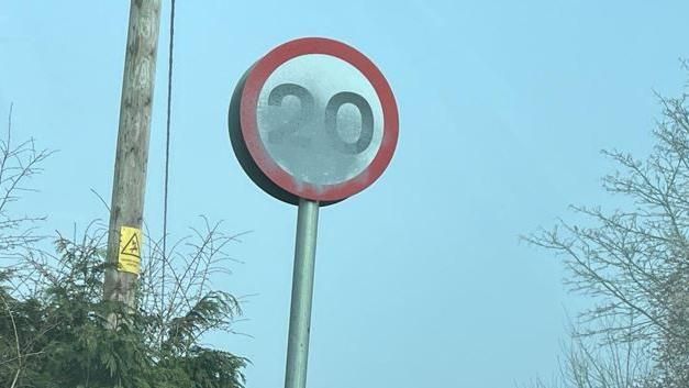 Defaced speed limit sign