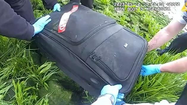 Officers from the Metropolitan Police dragging the suitcase from the river 