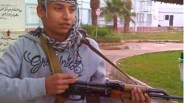Khairi Saadallah holding gun in Libya