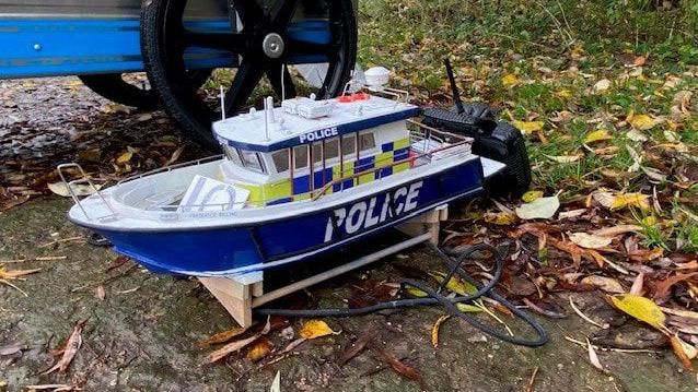 A electric powered police boat at the foot of the lake