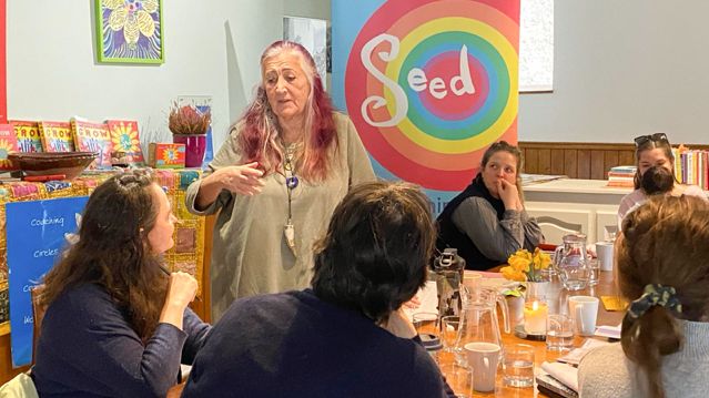 Lynne Franks talking to women sat at a table