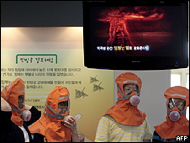 Jóvenes en Corea del Sur escuchan, en un cuarto de simulaciones, explicaciones del efecto de una bomba nuclear.