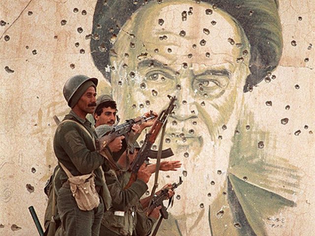 جنود عراقيون امام صورة للامام الخميني في الفاو اقصى جنوب العراق الذي احتلت القوات الايرانية جزءا منه في فبراير شباط 1986