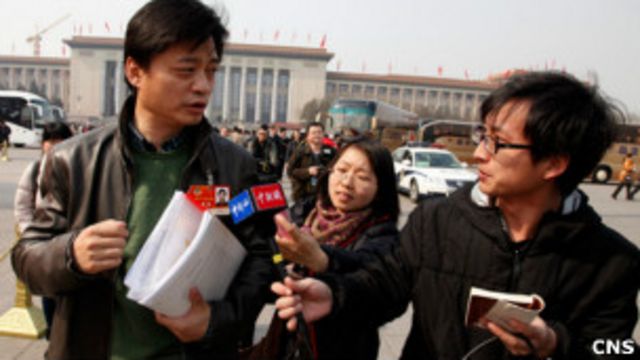 北京天安門廣場上記者追訪參與兩會的人大代表（中新社圖片5/3/2011）