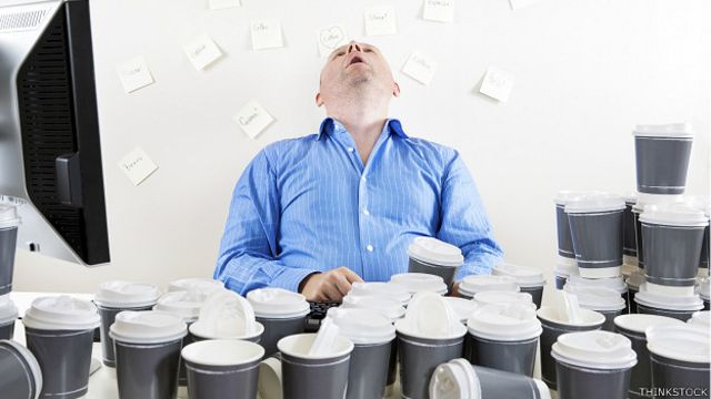 Executive who falls asleep in front of many glasses of coffee