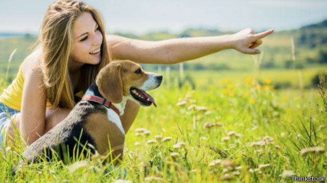 girl pointing with dog
