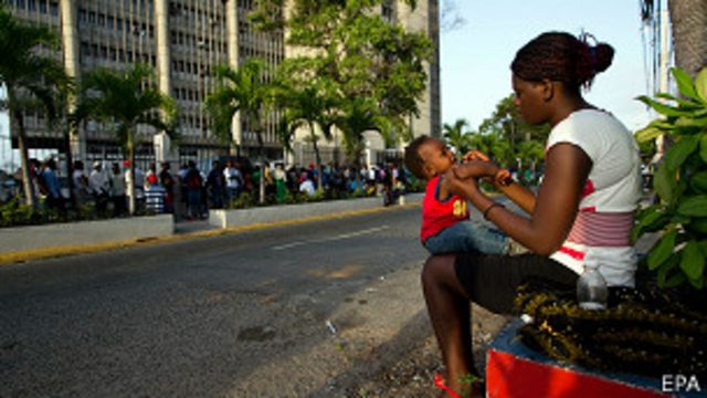 mujer haitiana hace cola para regularizar su situación en república dominicana