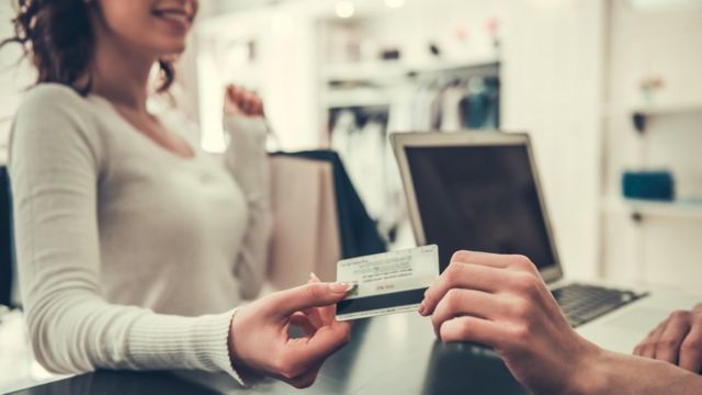 Woman paying with card (generic)